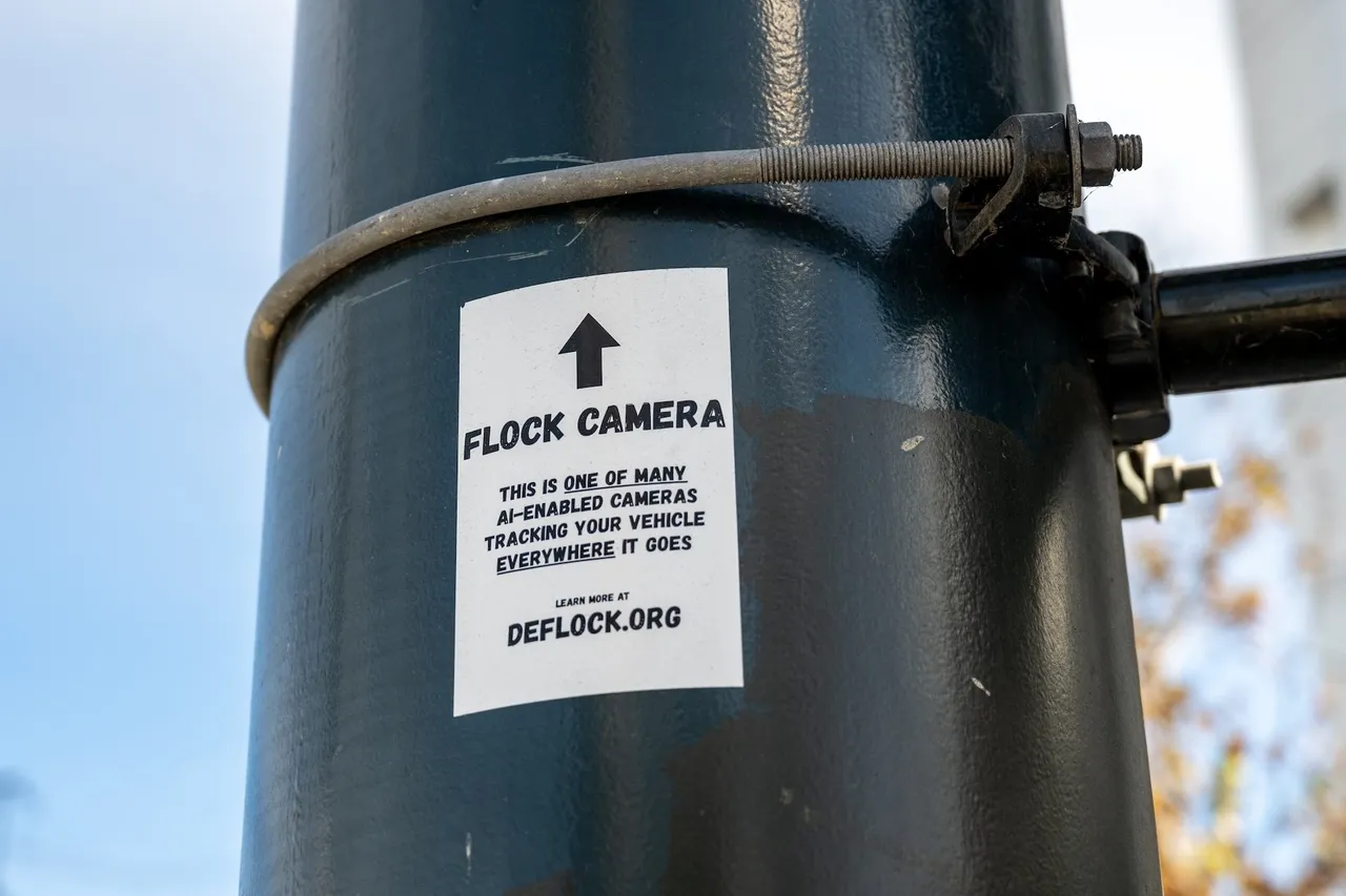 DeFlock privacy advocacy sticker warns of a nearby Flock Safety AI-enabled automated license plate reader tracking vehicles, San Francisco, California