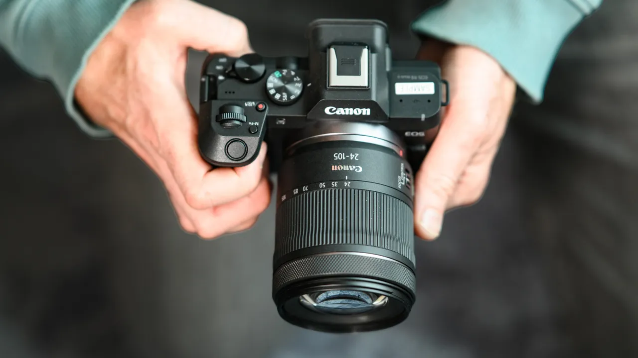 Top of the Canon EOS R8 Mark II, in user's hands, 24-105mm lens attached