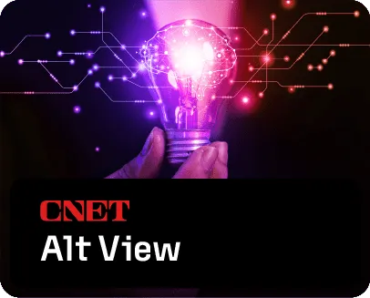 A glowing translucent lightbulb, held by a hand, in front of lighted lines suggesting a circuit board