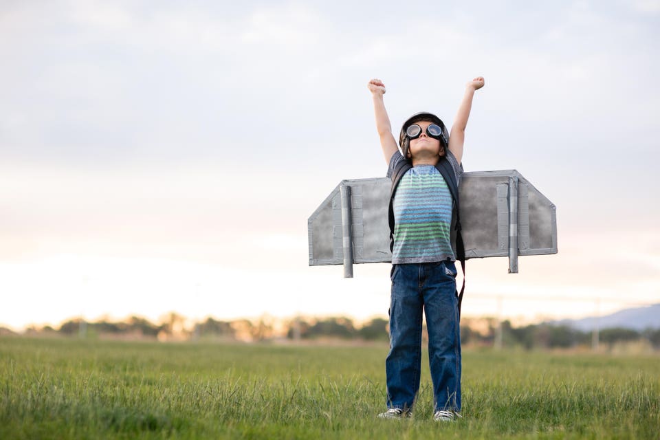 Young Boy with Jetpack in Grassy Field