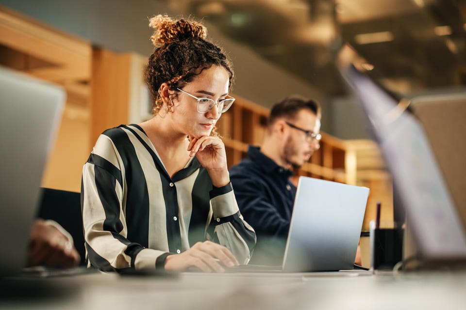 Woman working on computer in an office.