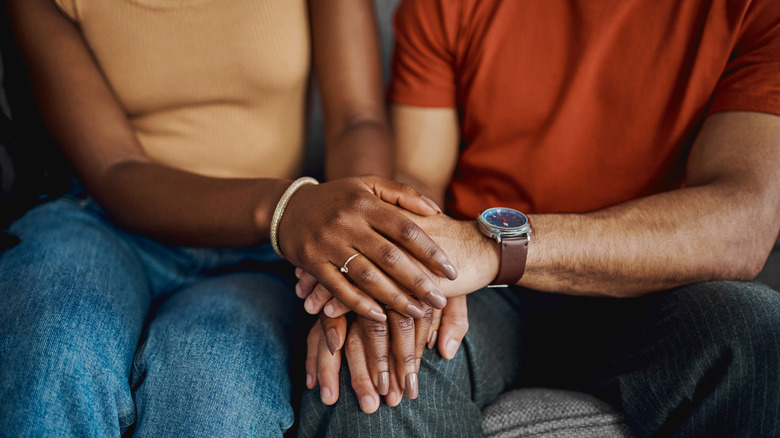 Two people holding hands.