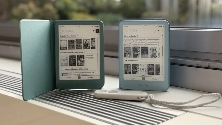 Ereaders by a window with a remote that has a wrist strap.
