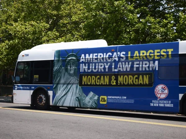 Morgan & Morgan injury law firm ad is seen on a bus in New York.