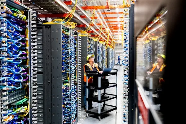 NEW CARLISLE, INDIANA - OCTOBER 2: In this handout provided by Amazon, a technician works at an Amazon Web Services AI data center in New Carlisle, Indiana on October 2, 2025.